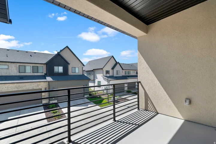 Private balcony featuring a concrete floor and contemporary horizontal metal railing