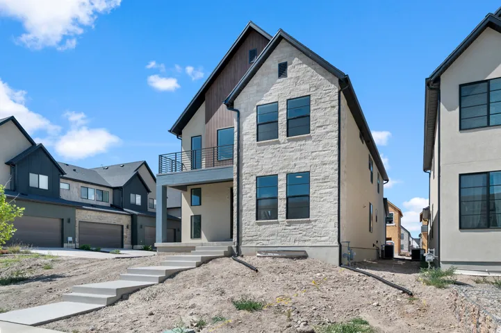 Modern contemporary exterior featuring stone veneer, stucco, and wood-finish siding