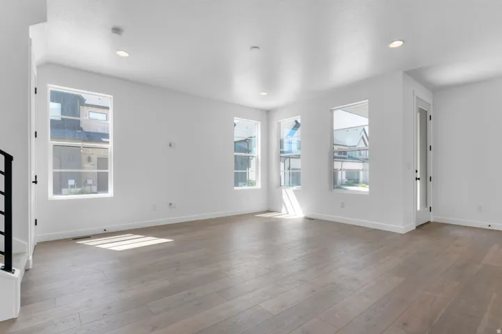 Bright living area featuring wood-finish flooring and recessed lighting