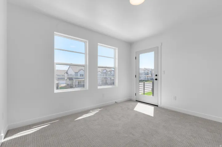 Bright room with two large windows and a glass-paneled door