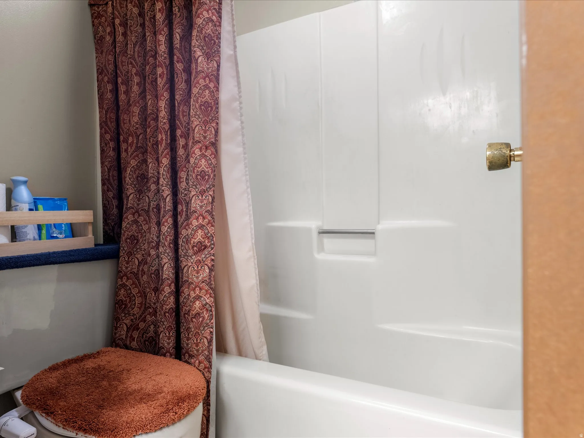 White acrylic bathtub and shower combination unit
