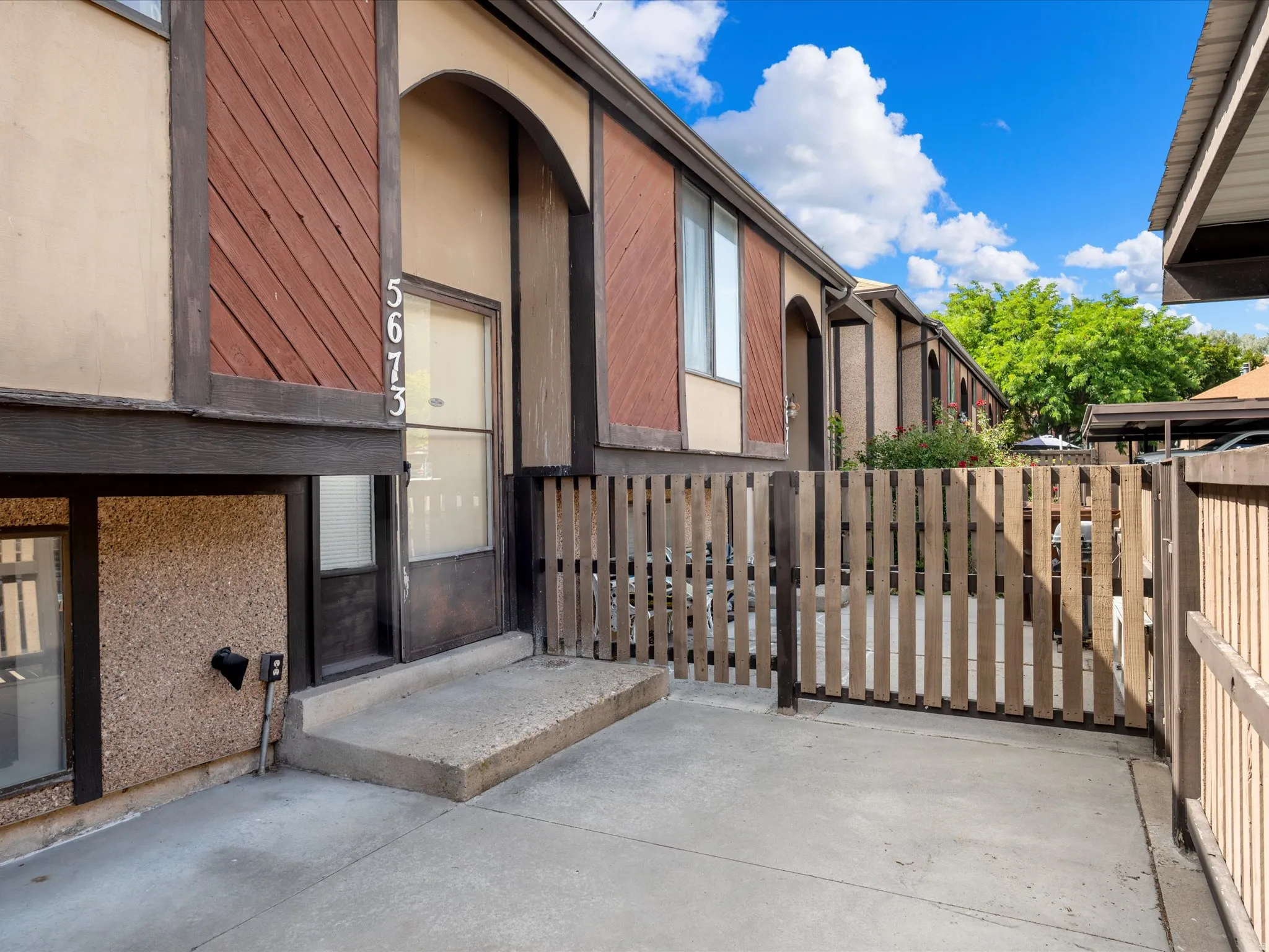 Concrete patio featuring a privacy fence and direct access to the front entry