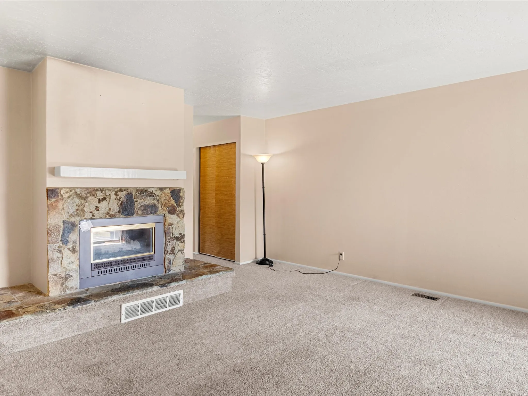 Stone-faced fireplace with a raised hearth and built-in insert