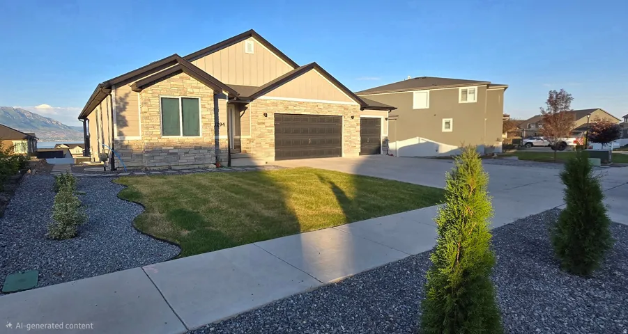 Modern ranch-style residence featuring a stone and siding facade, a two-car garage with a textured door, an additional single-car garage, and a manicured lawn with gravel landscaping beds