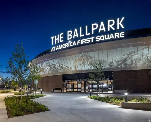Contemporary stadium exterior featuring a prominent illuminated sign