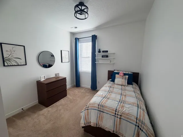 Bedroom featuring light-colored walls and carpet flooring