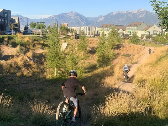 Community bike park featuring dirt trails and natural landscaping