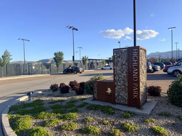Highland Park signage featuring a gabion stone and rusted metal design