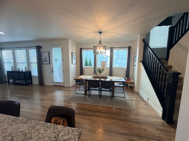 Open concept living area featuring wood-finish flooring