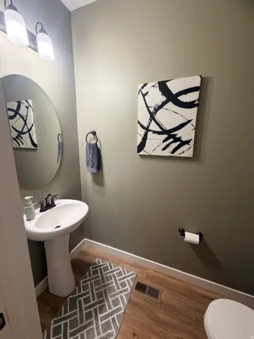 Pedestal sink with dark bronze faucet