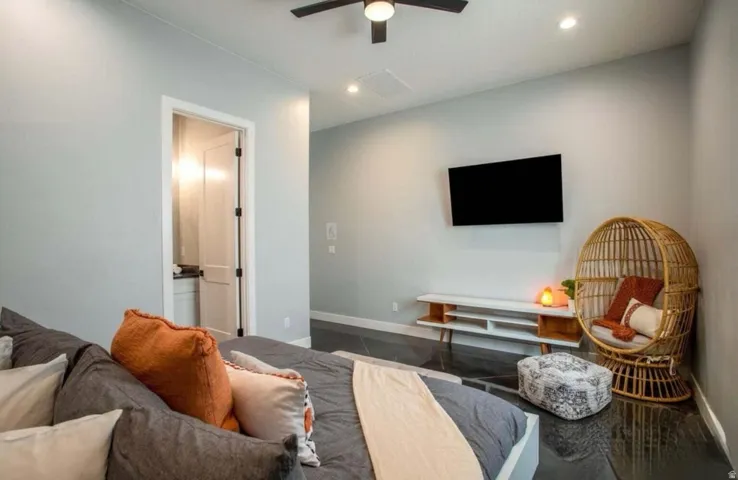 Recessed lighting, ceiling fan, hard-surface flooring, and a built-in media console
