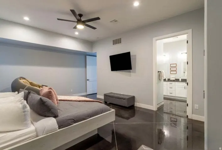 Recessed lighting, ceiling fan, dark wood-finish flooring, white trim, and a built-in television mount