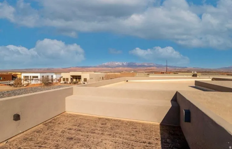 Rooftop patio featuring textured pavers and low perimeter walls