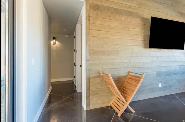 Accent wall with horizontal wood paneling and a mounted light fixture
