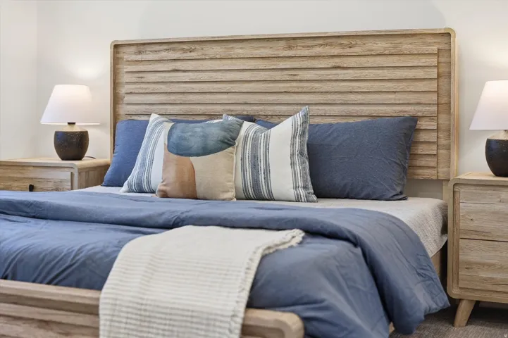 Wood-finish slatted headboard with corresponding wood-finish side tables