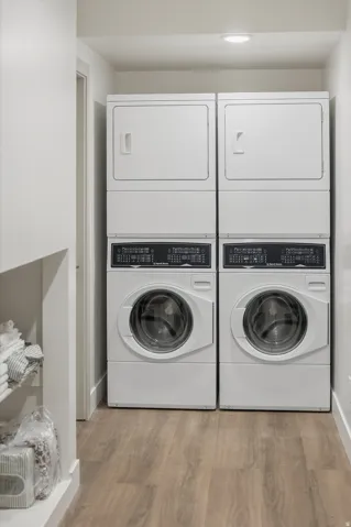 Dedicated laundry area featuring two stacked washer and dryer units