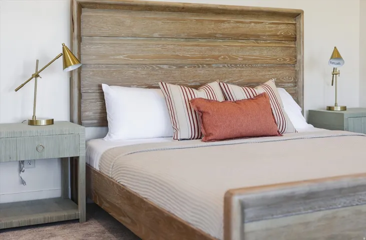 Wood-finish bed frame featuring a slatted headboard