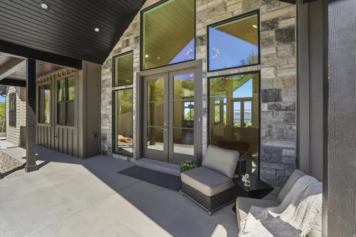 Stone and siding exterior with a covered concrete patio