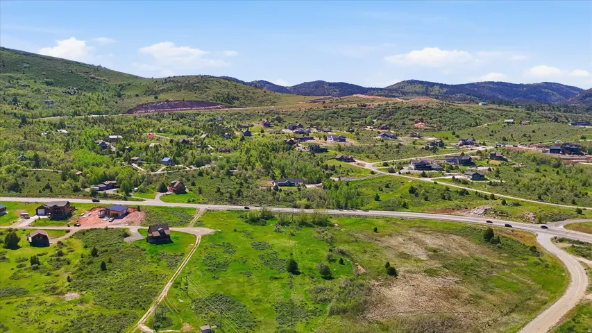 Expansive hillside property featuring established residential development, undeveloped land, and paved roads
