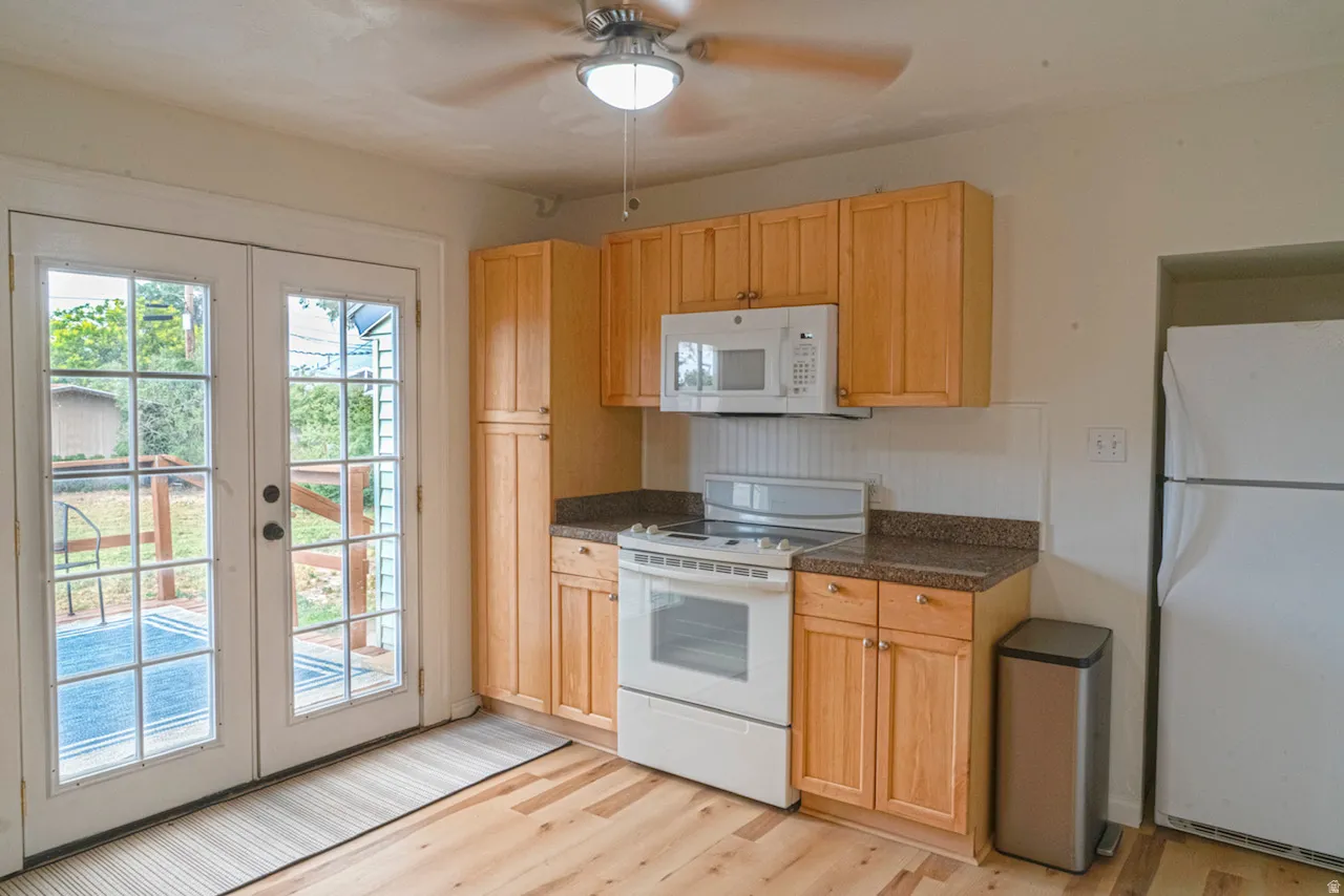 Kitchen with wood-finish flooring and light wood cabinetry