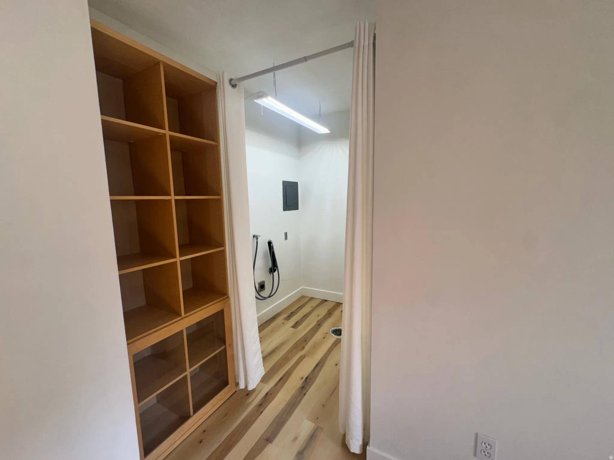 Built-in shelving unit with open display and glass-fronted storage