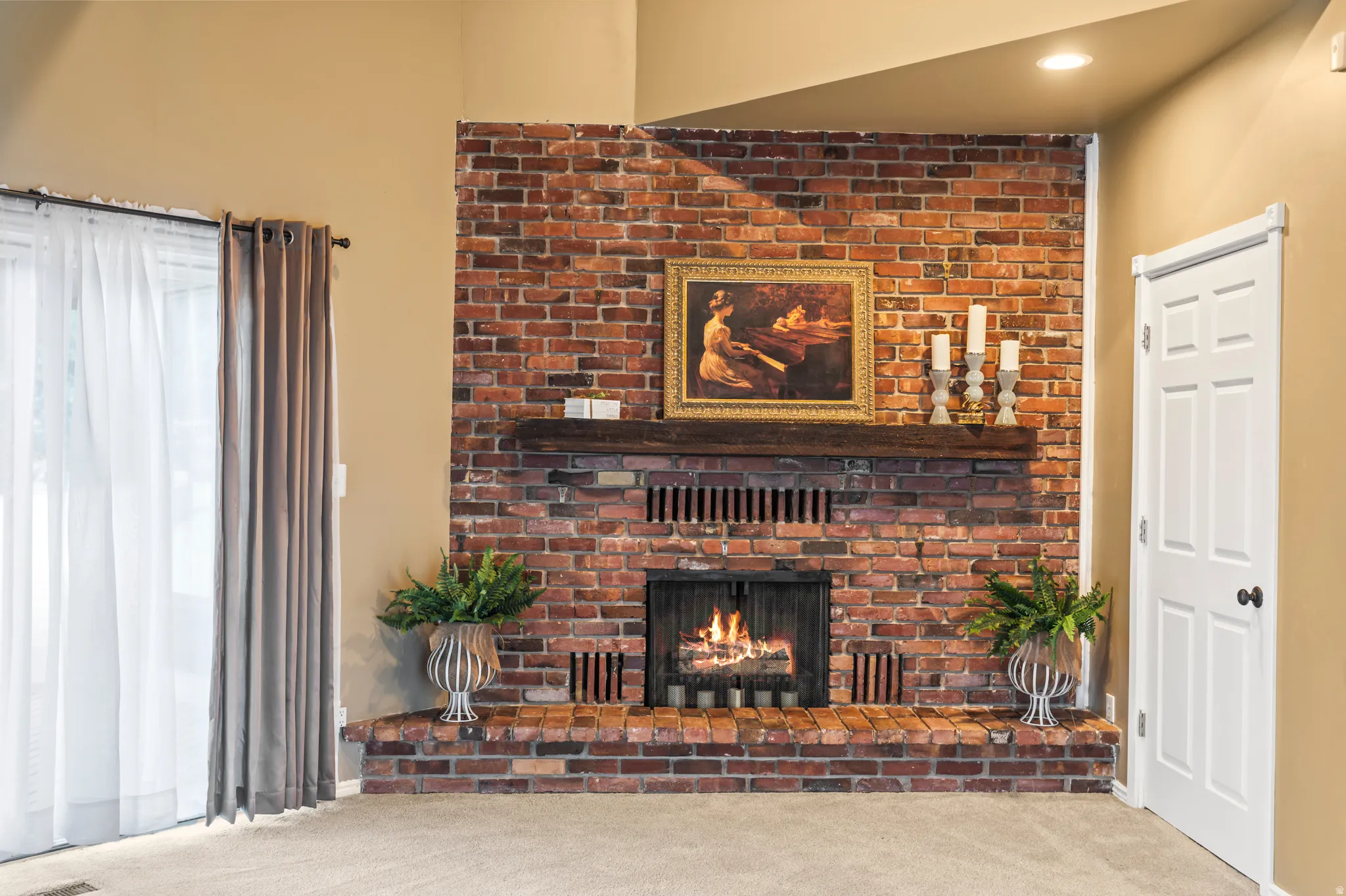 Brick fireplace with a wood mantel and hearth