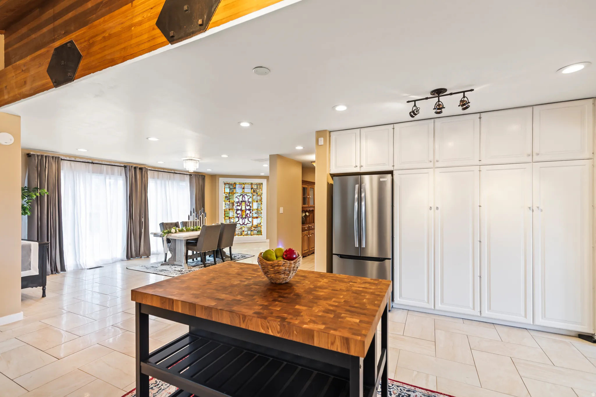 Kitchen island with a butcher block countertop and open shelving