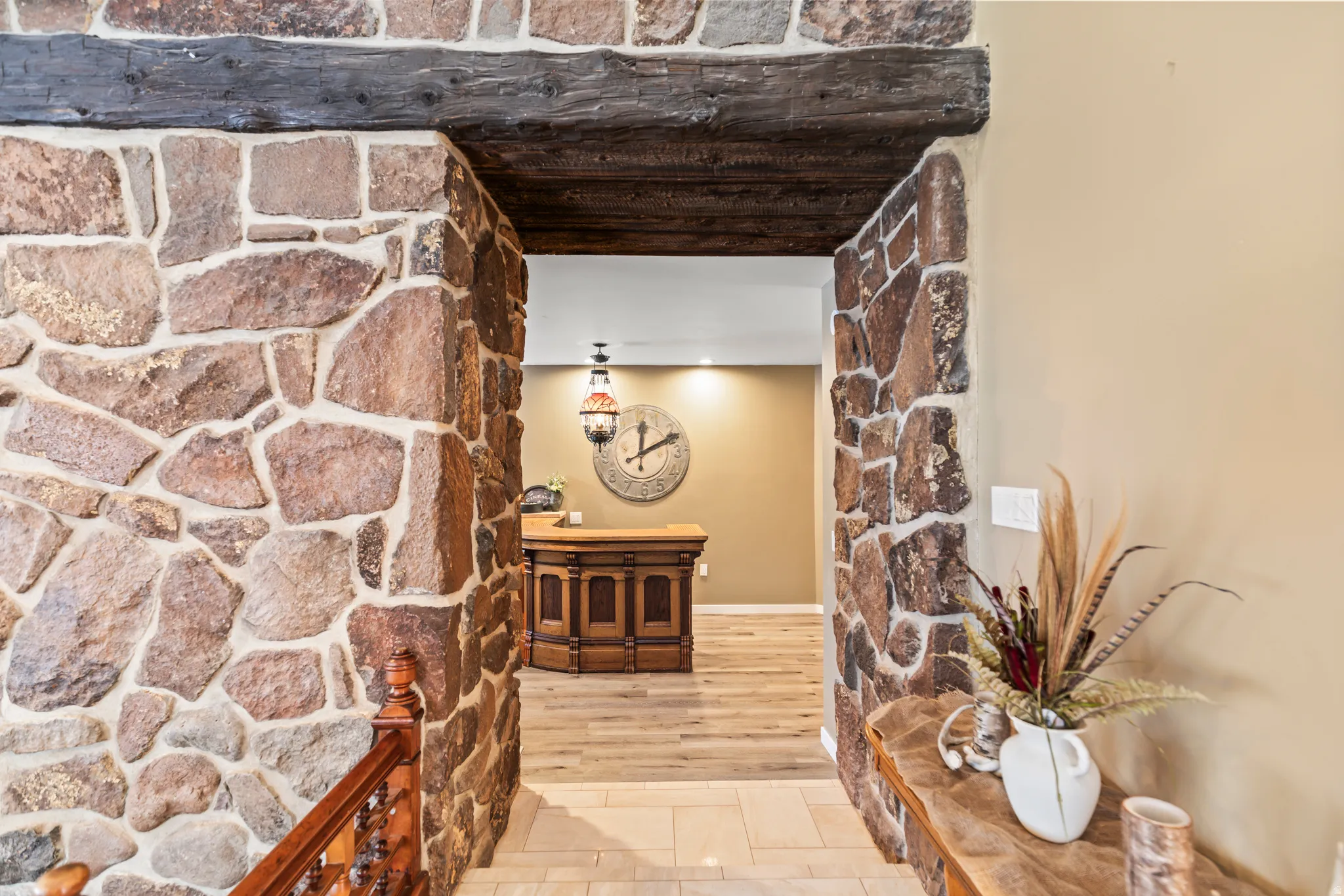 Stone archway entrance featuring an exposed wood beam