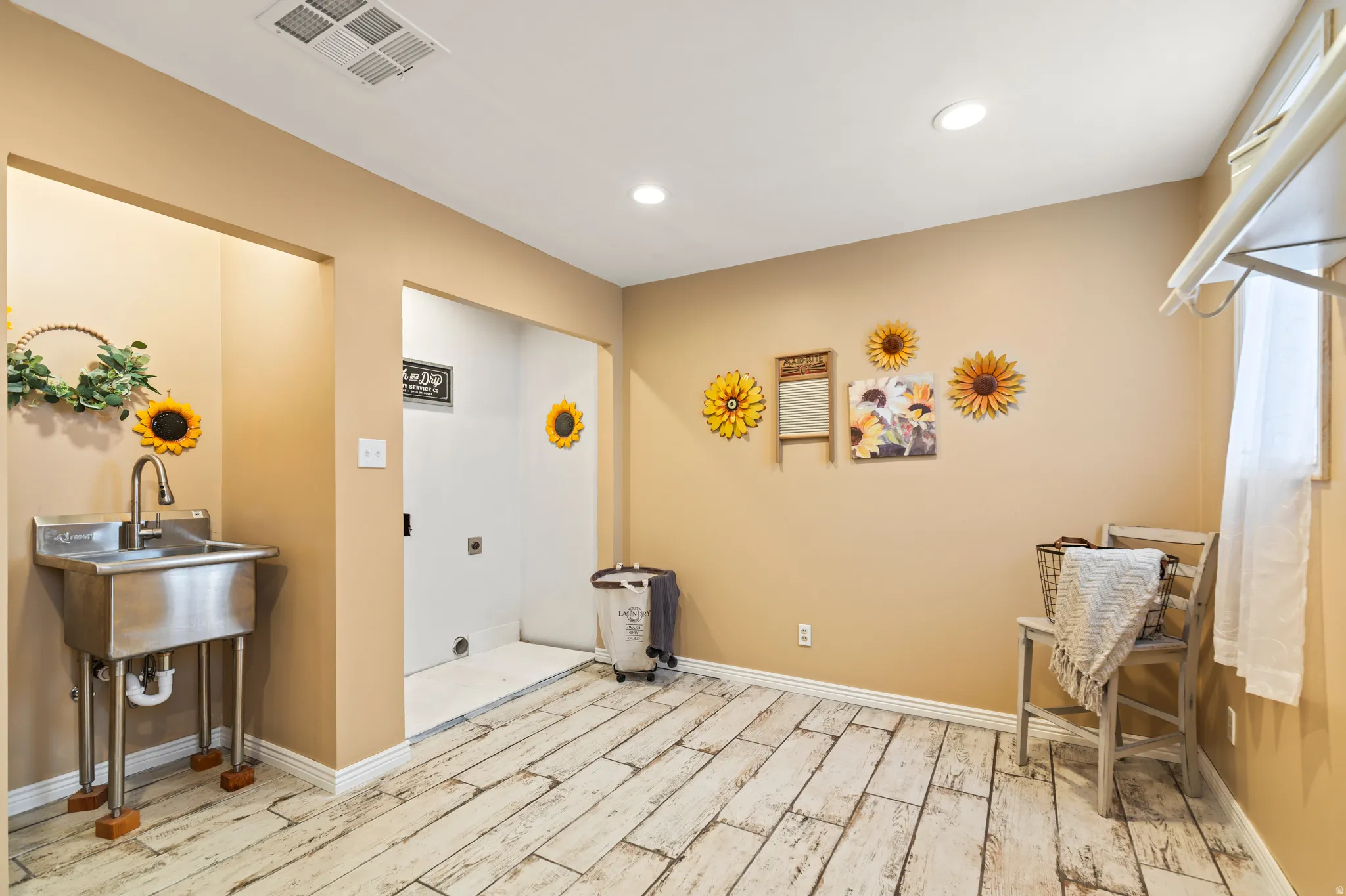 Utility room featuring wood-finish flooring, recessed lighting, and a stainless steel utility sink with a high-arc faucet