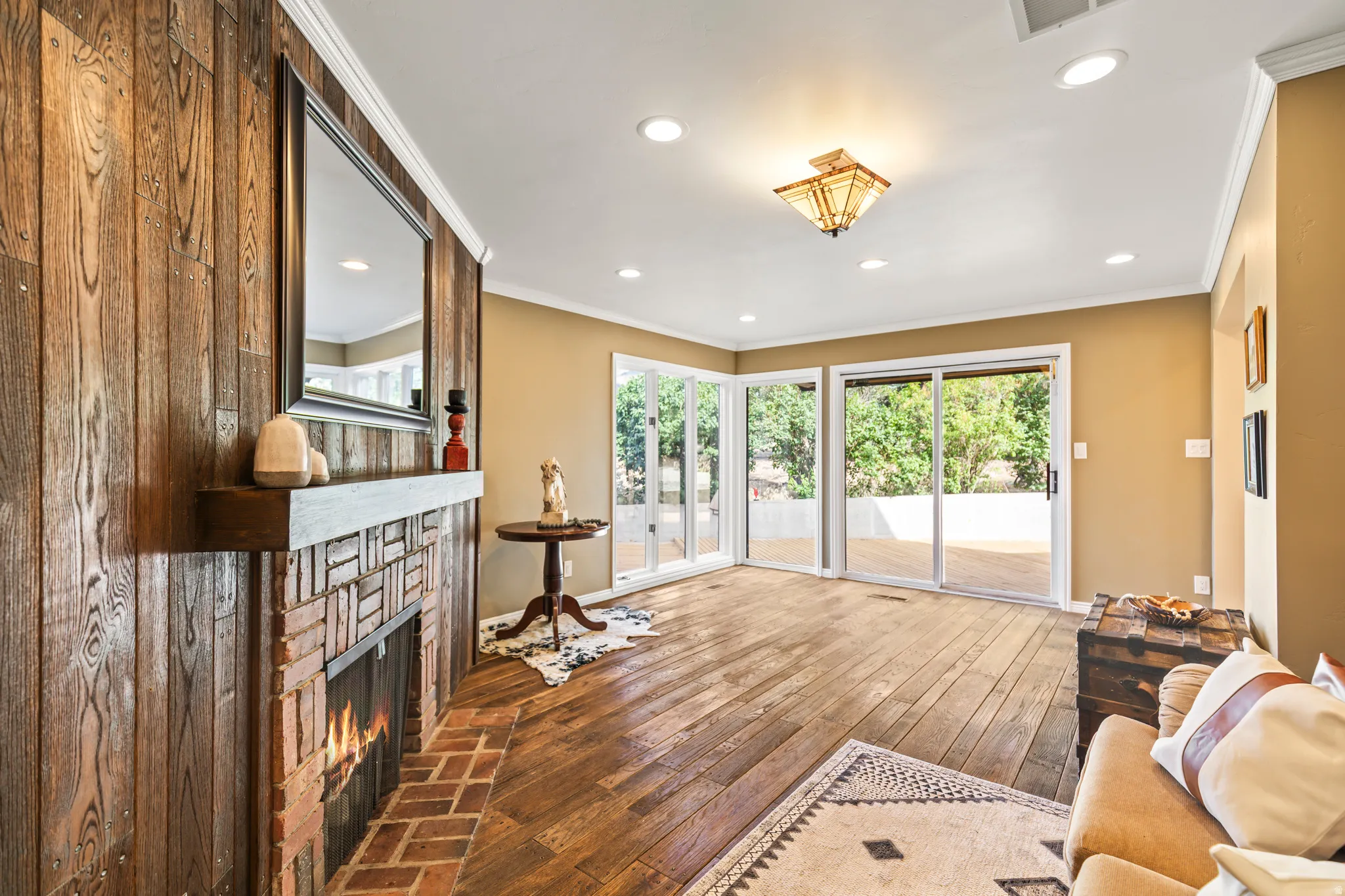Brick fireplace with a wood-plank accent wall and floating mantel