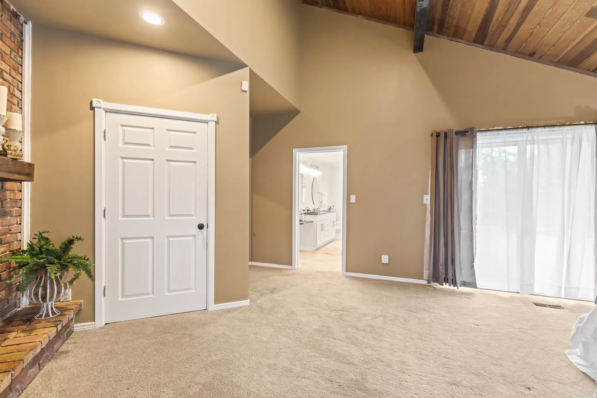 Vaulted wood-paneled ceiling with exposed beam