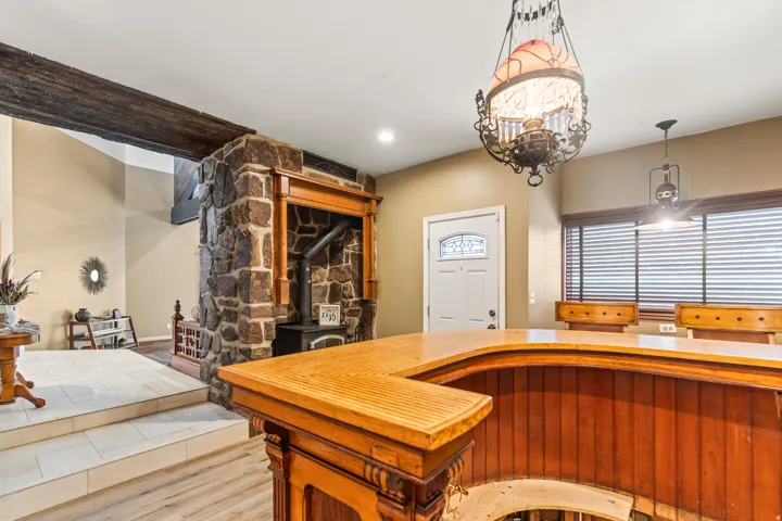 Wood-finish bar with a solid surface countertop and built-in paneling