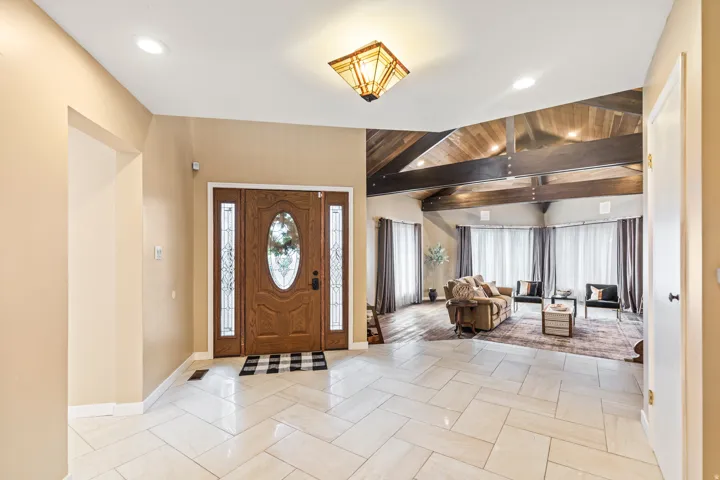 Foyer featuring herringbone-patterned tile flooring, a recessed lighting scheme, and a decorative ceiling fixture