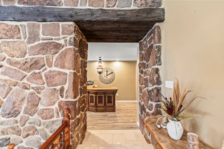 Stone archway entrance featuring an exposed wood beam