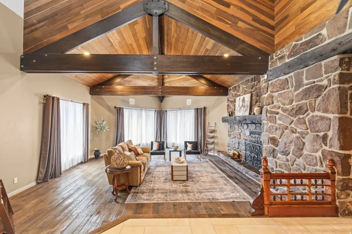 Vaulted wood-paneled ceilings with exposed beams and recessed lighting