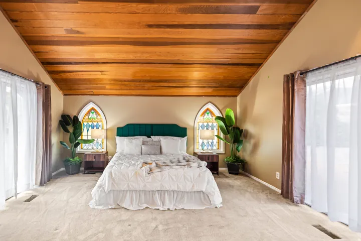 Vaulted wood-paneled ceiling with recessed lighting