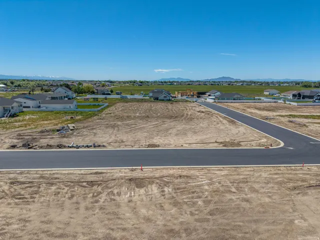 Expansive undeveloped land parcel with newly paved streets and curb cuts