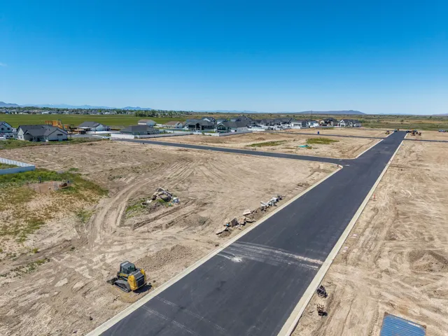 Newly paved roads with curb and gutter infrastructure within a developing subdivision