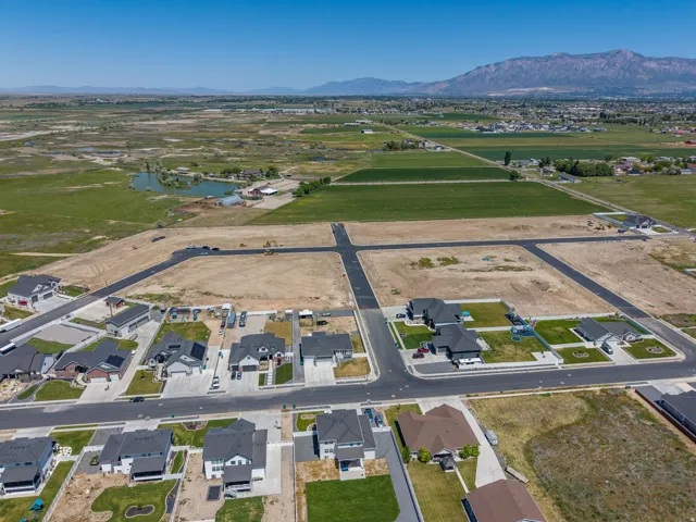 Aerial perspective showcasing a developing residential community with paved streets and established homes