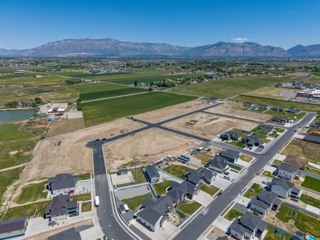 Aerial perspective showcasing a developing residential area with paved streets and established homes