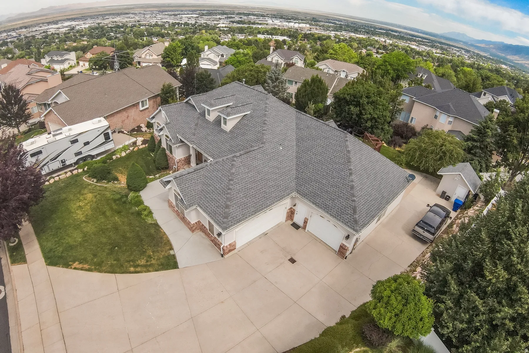 Expansive residential property featuring a multi-gabled roofline and a brick and siding exterior