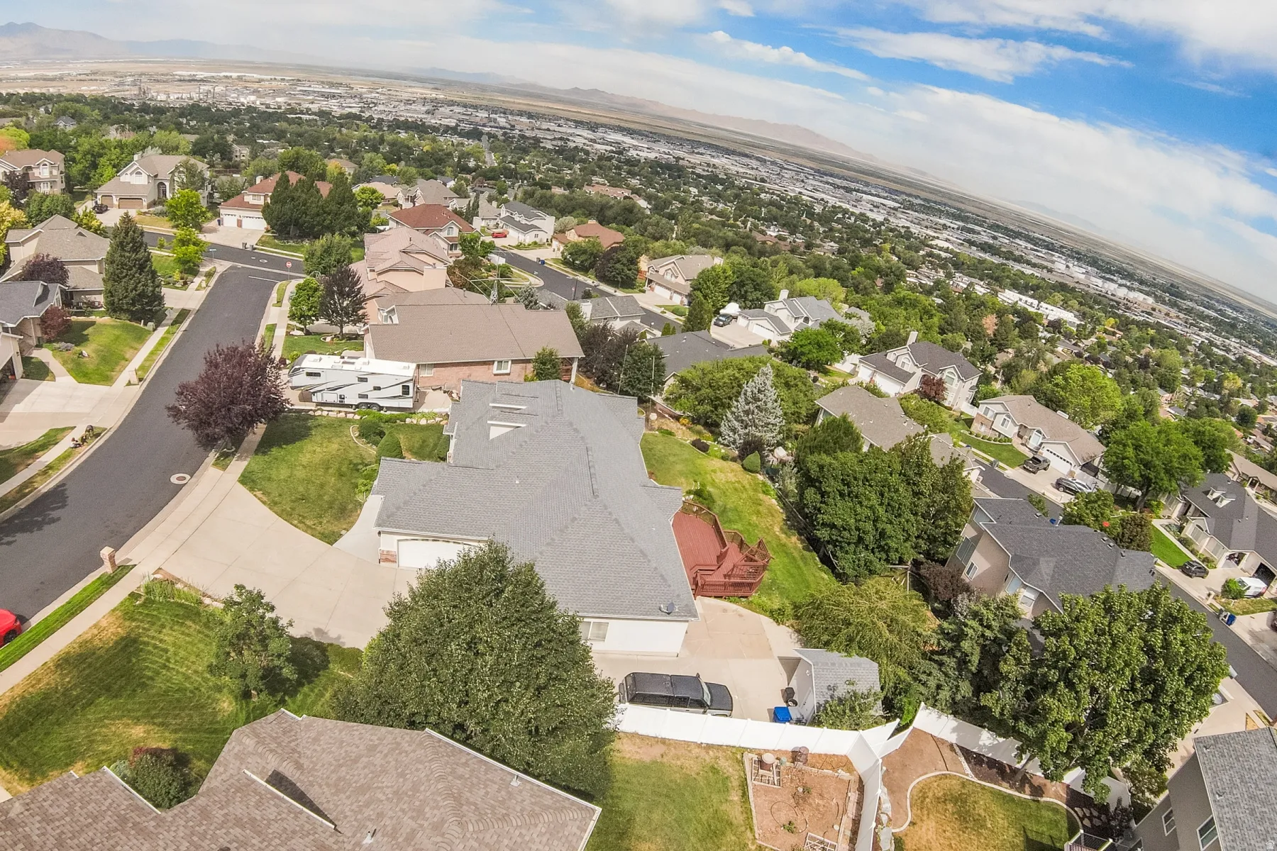 Residential neighborhood with mature trees, paved streets, and varied architectural styles