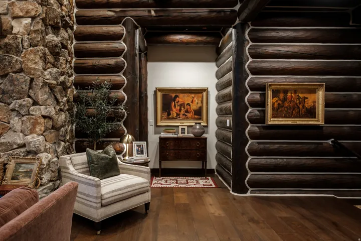 Hardwood flooring complementing log wall construction and stacked stone accent wall