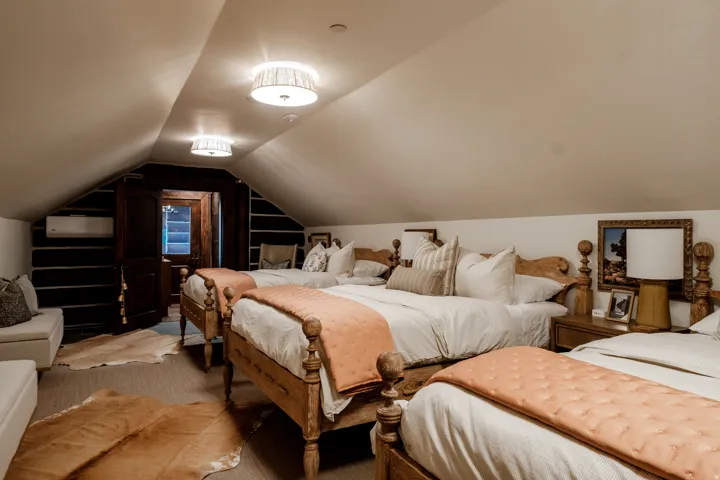 Attic space featuring sloped ceilings and exposed wood beams