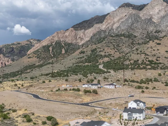 Mountainous terrain and development featuring paved roads and several residential structures