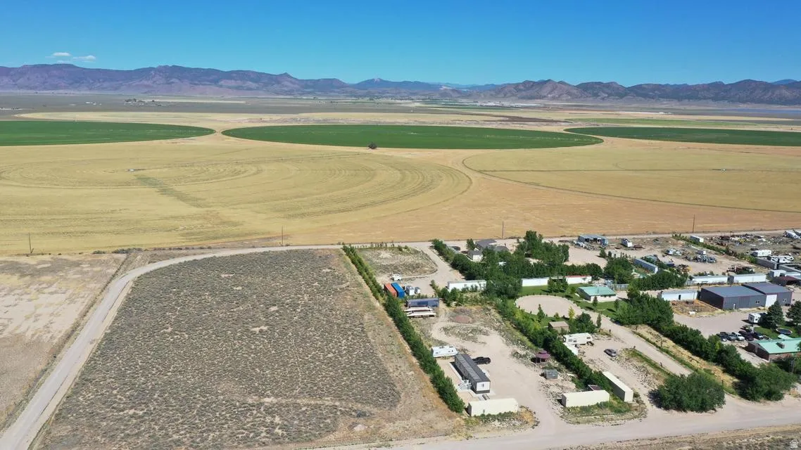 Expansive land parcel featuring a gravel road and natural desert landscaping