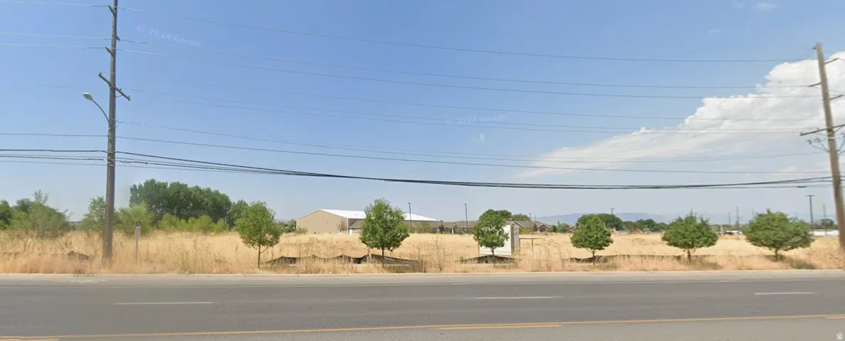 Expansive land parcel featuring existing trees and clear sky