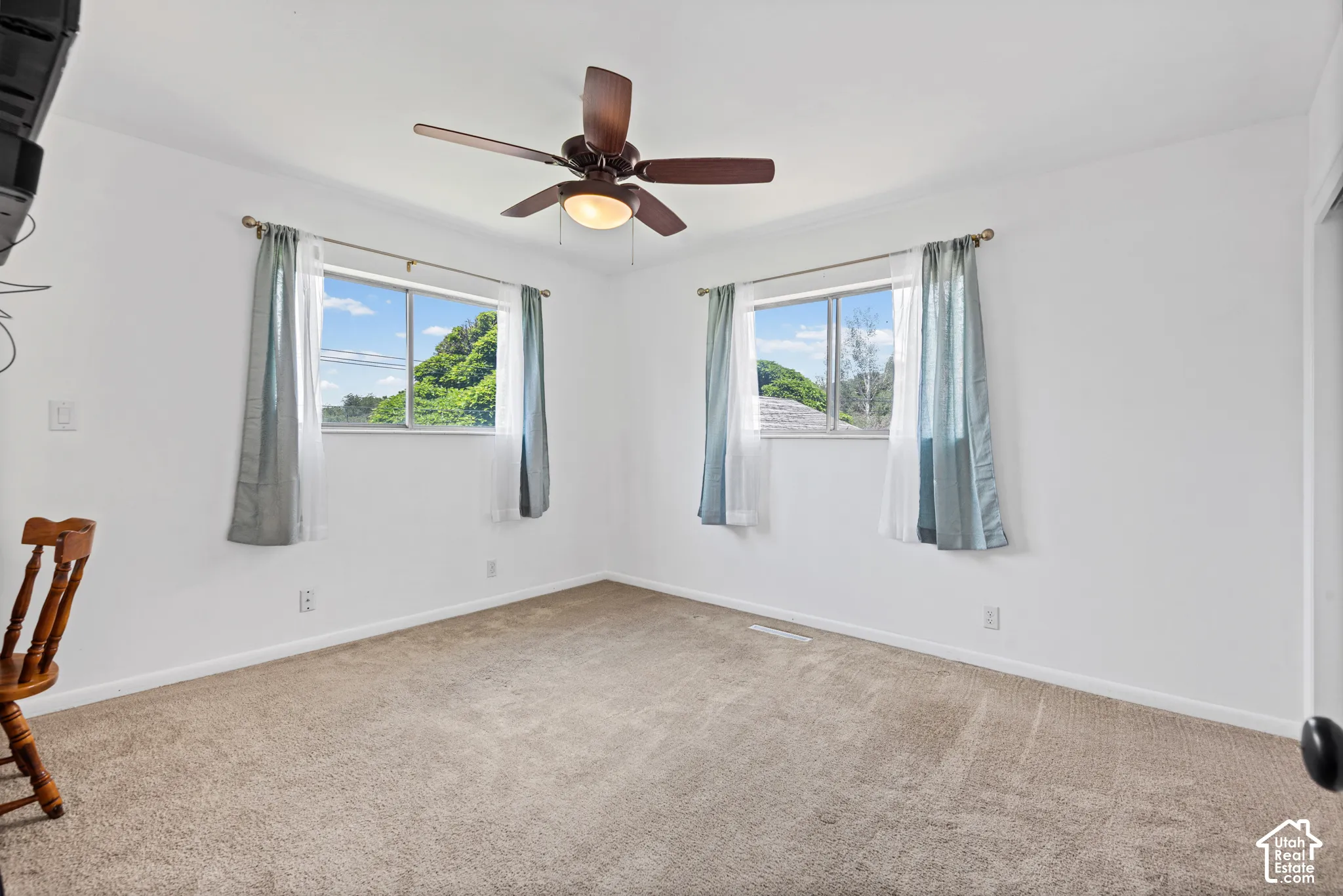 Neutral-toned carpeting and white walls create a versatile interior