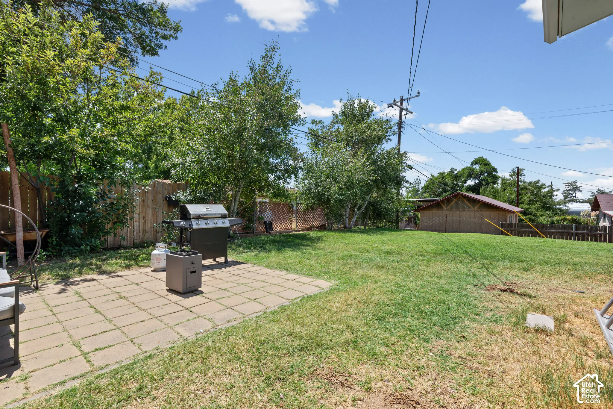 Expansive backyard featuring a paver patio and ample green space