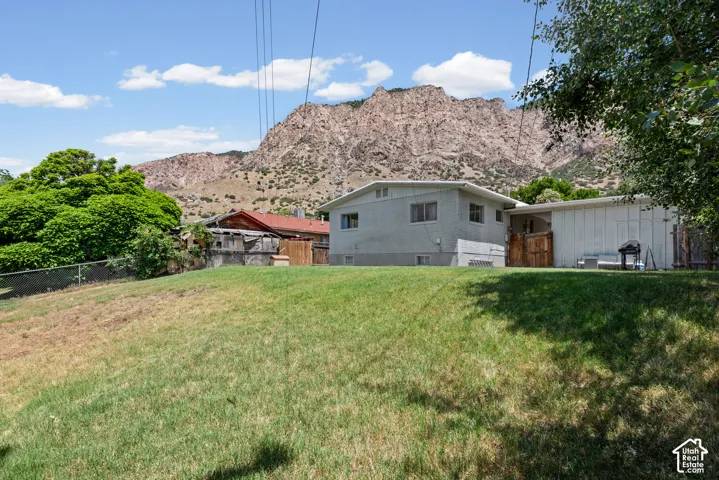 Expansive grassy yard with mountain scenery